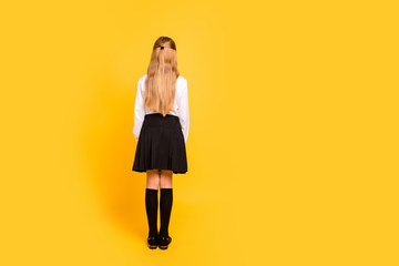 Fototapeta premium Rear back behind full length body size view of her she nice-looking attractive straight-haired pre-teen girl standing still isolated on bright vivid shine yellow background