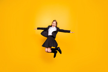 Fototapeta na wymiar Full size photo of pretty kid raise hands laugh jump isolated over yellow background