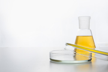 Chemistry glassware with yellow liquid for science research and experiment.