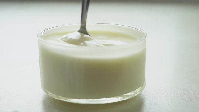 video shooting of mixing yogurt with spoon in the cup