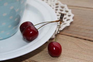 cherries in a bowl on wooden table
