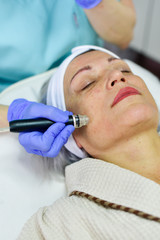 Fototapeta premium Woman receiving Hydrodermabrasion Facial therapy