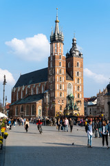Naklejka na ściany i meble Cracow Krakow Poland - April, 2019: St Mary's Basilica Mariacki Church and The Main Market Square in the Old Town of Krakow.