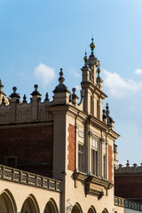 Obraz premium Krakow, Poland - April, 2019: Old city center view with Adam Mickiewicz monument and St. Mary's Basilica in Krakow