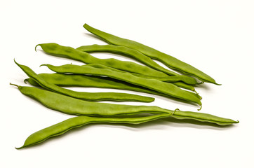 Harvested unripe green bean pods for food use on a white background
