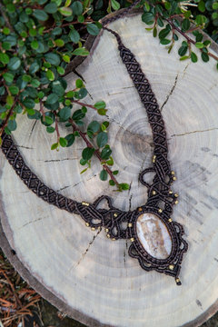 Macrame necklace with natural mineral gemstone on natural background
