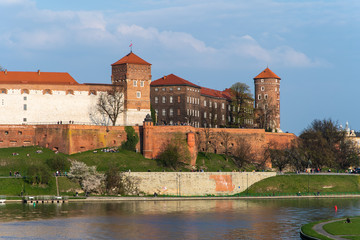 Naklejka na ściany i meble Krakow, Poland - April, 2019: Wawel castle famous landmark in Krakow Poland. Picturesque landscape on coast river Wisla.