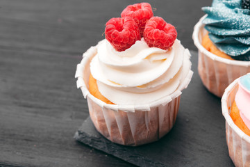 Set of different delicious cupcakes on dark