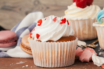 Tasty cupcakes on a dark wooden table