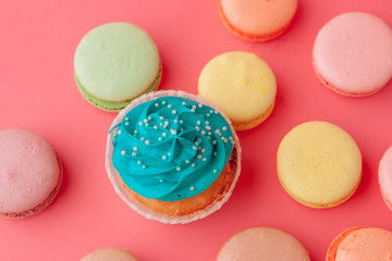 Tasty cupcakes sweets on pink background close up