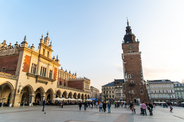 Naklejka premium Krakow, Poland - April, 2019: Church of St. Mary and the Cloth Hall on the main market square in Krakow