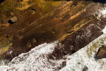 Rocky ledge at low tide drone POV Sydney Northern Beaches Australia