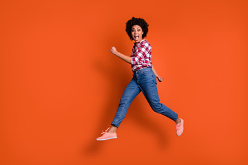 Fototapeta na wymiar Full body side photo of excited jumping high lady yelling loud sale discount shopping wear casual clothes outfit isolated orange background