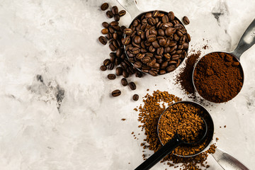 Coffee concept - beans, ground, instant, capsules marble background top view