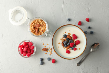 Flat lay composition with parfaits dessert and ingredients on white cement background