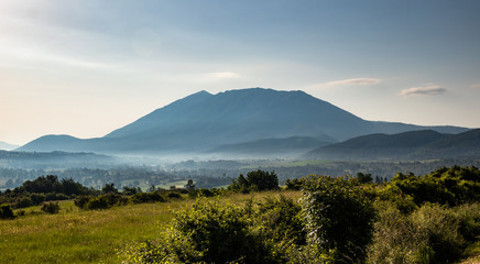 Obraz premium Mountain in the morning and fog under the top. Rtanj mountain in Serbia.