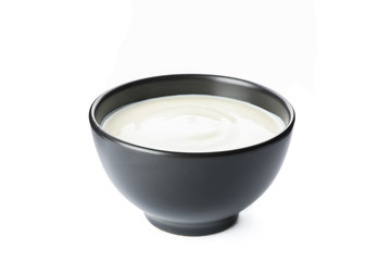 Bowl of sour cream yogurt isolated on white background