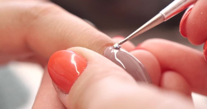 Close up of Beautician Putting a Strass on the Nail in Beauty Manicure Salon