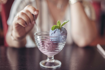 girl and ice cream in a glass in cafe