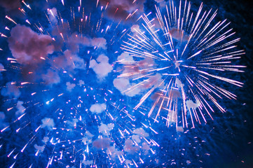 Inexpensive fireworks, over the city, red and blue . Selective focus. For any purpose. 