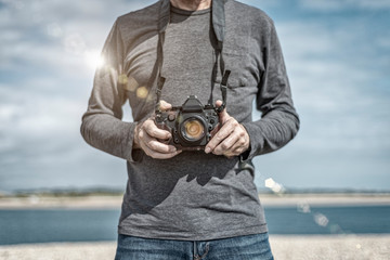 man holding a retro camera