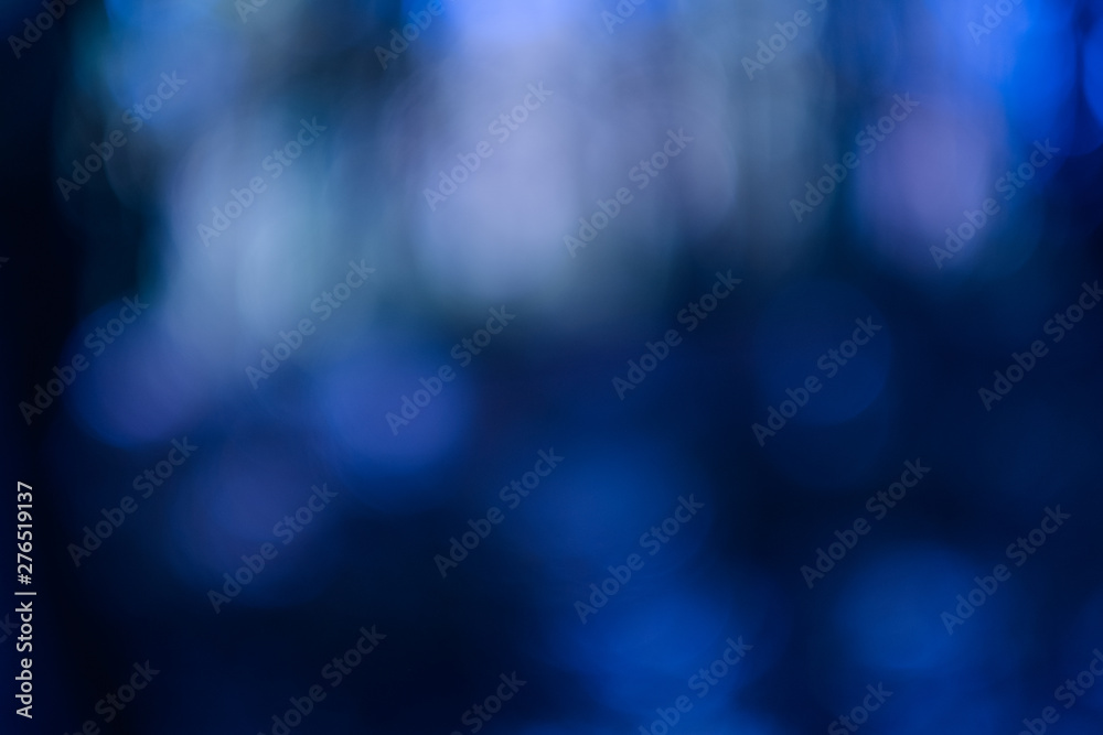 Wall mural Navy blue bokeh lights. Defocused lens flare effect. Dark abstract art background.