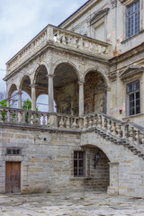 Obraz premium The medieval architecture of Europe. Old stone castle. Pidhirtsi Castle. Reconstruction of a historic building. Pillars and stairs. Castles of Western Ukraine. Location for the film.