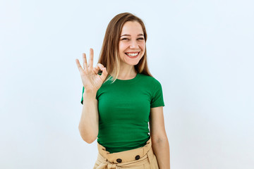 Okay symbol. Portrait of young girl who a showing agree and approval sing.