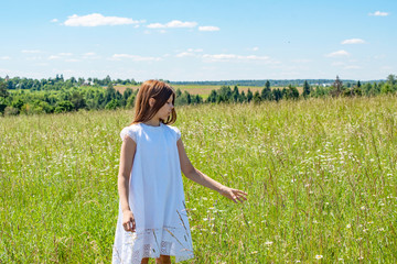 girl in white dress in summer field