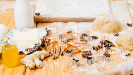 Chef workplace. Creative mess on kitchen table. Ingredients and tools for making gingerbread...