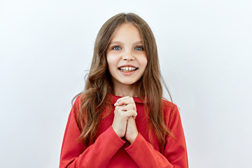 Beautiful child girl portrait against white background. Laughter and joy emotions