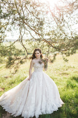 Fototapeta premium Beautiful bride near the tree