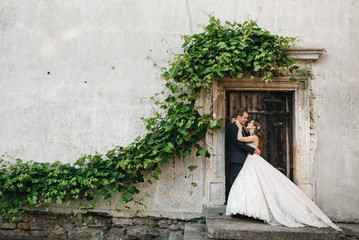 Happy bridesmaids are photographed near the old house
