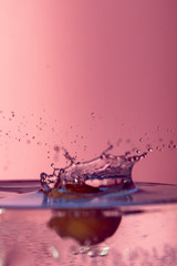 Water splash isolated on pink background, water bubble, detailed picture, natural elements.