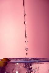 Water splash isolated on pink background, water bubble, detailed picture, natural elements.