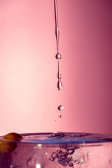 Water splash isolated on pink background, water bubble, detailed picture, natural elements.