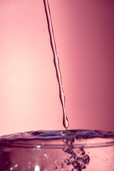 Water splash isolated on pink background, water bubble, detailed picture, natural elements.