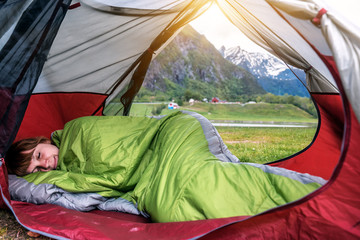 girl sleeps in the tent in mountain