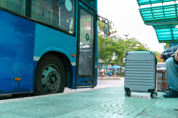 Luggage of a traveller at bus stop with the bus on background