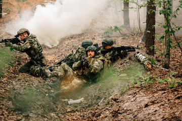Soldiers in a combat situation. Men play airsoft.