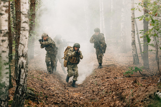 Soldiers in a combat situation. Men play airsoft.