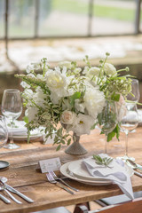 Closeup of the decoration of the wedding table with flowers in a rustic style for guests at a wedding or birthday party