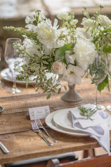 Decoration of the wedding table with flowers in a rustic style for guests at a birthday party