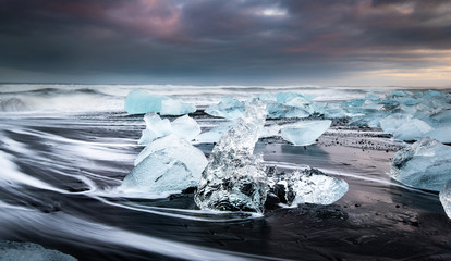 Diamond beach is one of the most impressive place in Iceland. Here, the ice on top of the volcanic sand captured in the sunset time just before the storm hits to the shore.