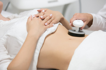 Obraz na płótnie Canvas Slim woman getting anticellulite and anti fat therapy in beauty salon