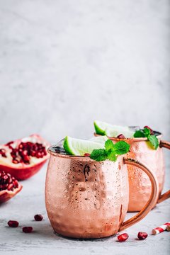 Iced Cold Moscow Mule cocktail with lime and pomegranate