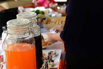 the bottle of orange and black  juices on table at  party event