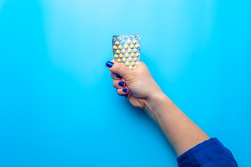 Close-up female hands are holding blister pack