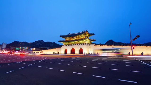 Night Time lapse of fast cars movement with neon lights glowing made on cross road in front of Gwanghwamun Gate, Gyeongbokgung Palace Seoul