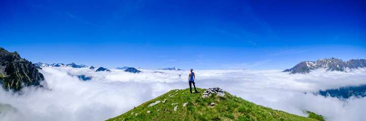 Above the clouds in the mountains of Oisans, Ecrins National Park, French Alps.